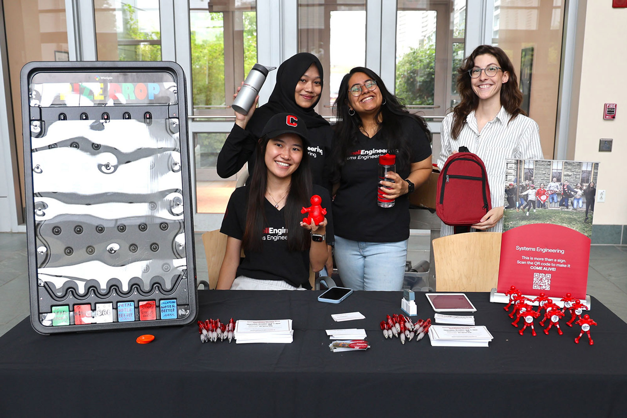 Master of Engineering program staff and students at the M.Eng. Expo exhibit table
