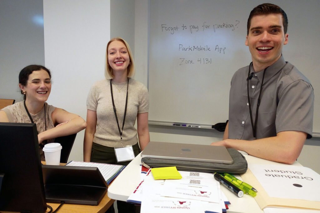 NYDBER 20126 organizers Maggie, Cara, Austin stand together in a Weill Hall classroom.
