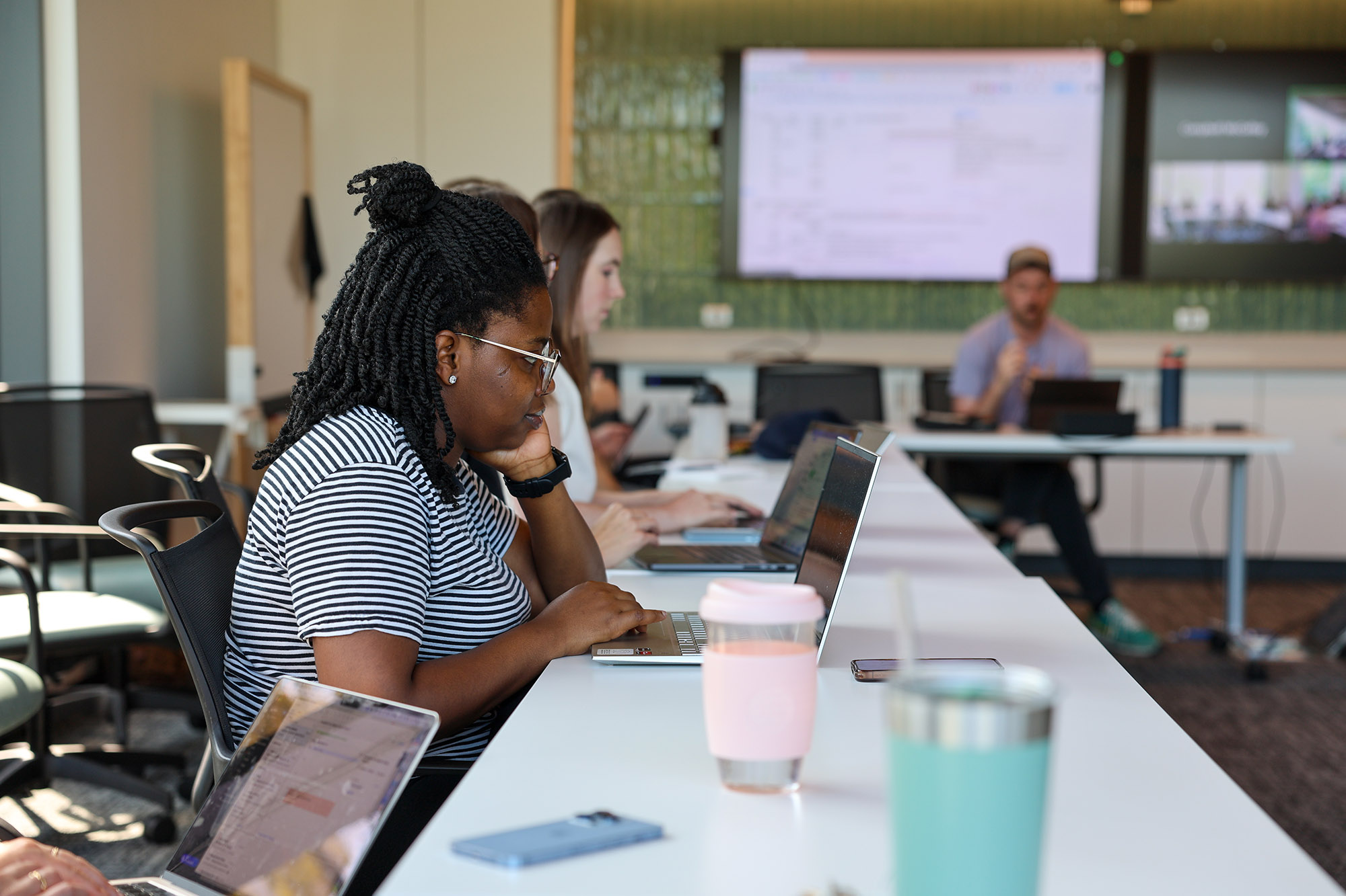 Person working on a laptop during a seminar