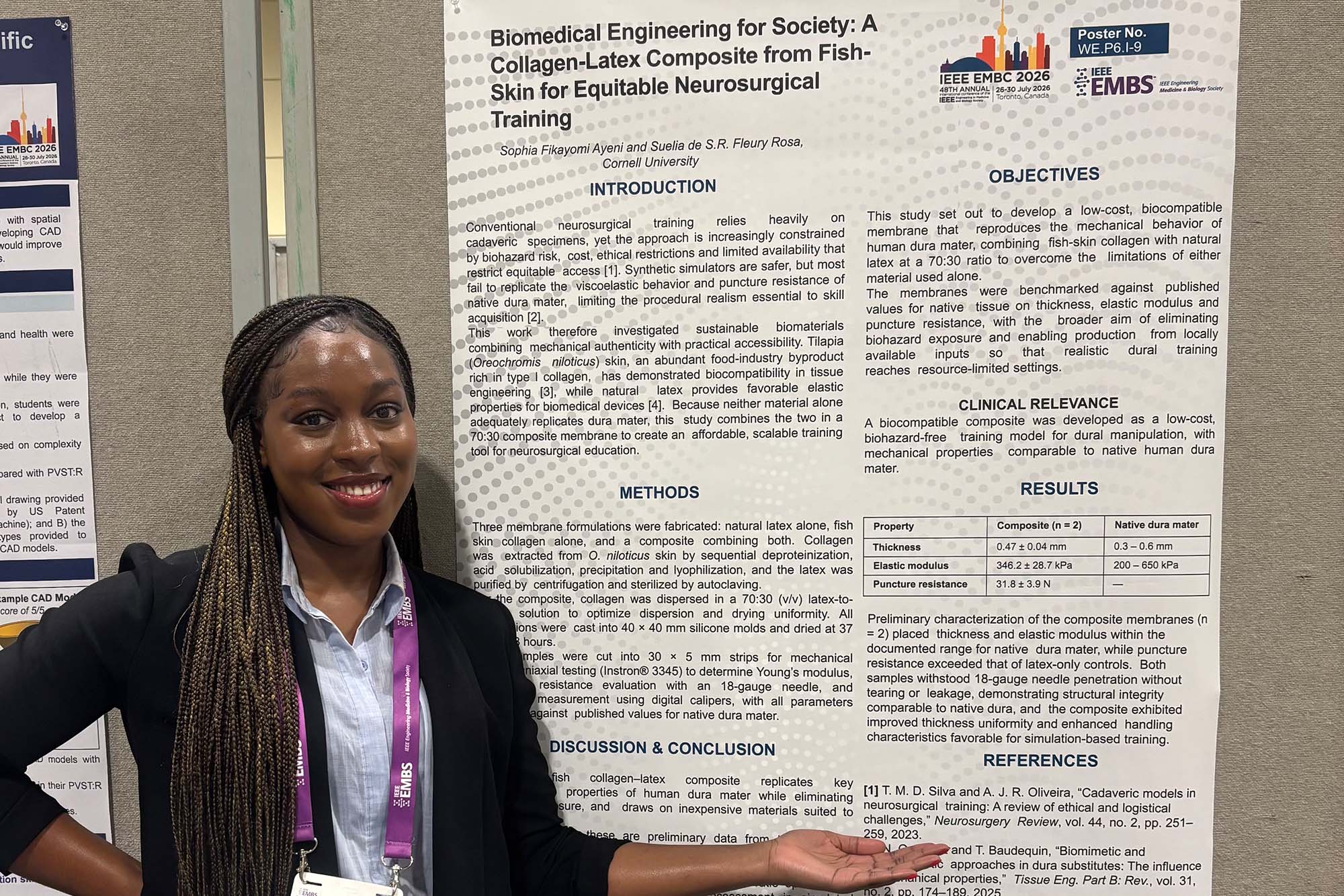 MEng student Sophia Ayeni stands with her poster at the Engineering in Medicine and Biology Conference (EMBC) conference exhibition hall in Toronto.