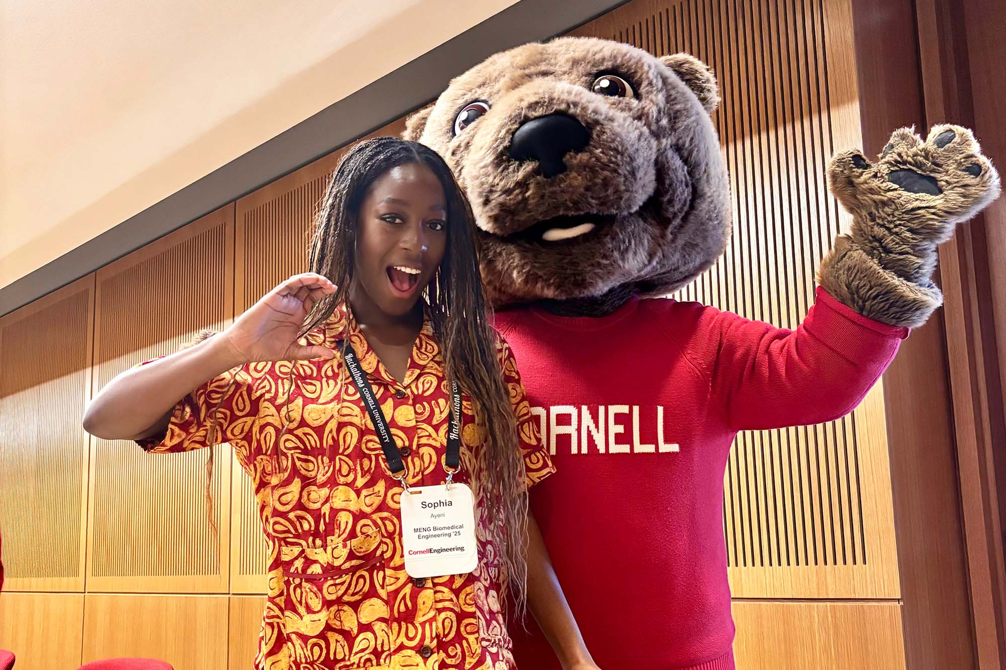 MEng student Sophia Ayeni poses with Cornell mascot Touchdown the bear.